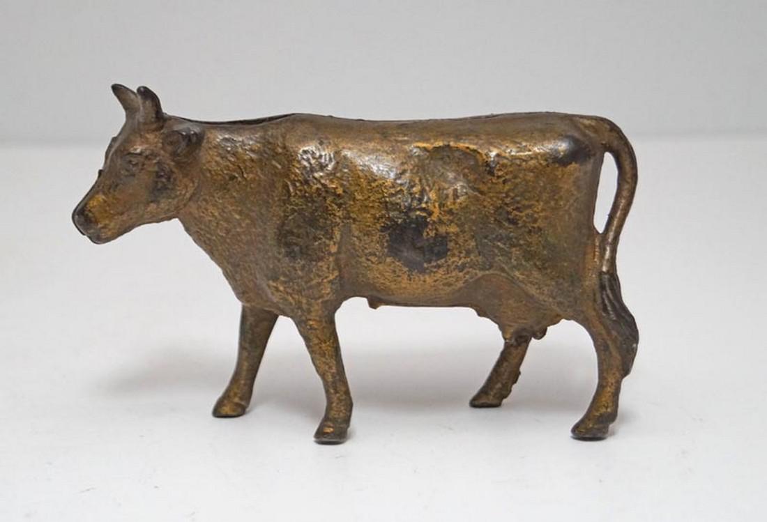Antique Cow Cast Iron Penny Still Bank: Title: Antique Cow Cast Iron Penny Still Bank Date: Circa 1920's. Dimension: 3 3/8" tall x 5 1/4" long. Provenance/Additional Info: A really nice example of our barn yard friend. Made of cast iron in 