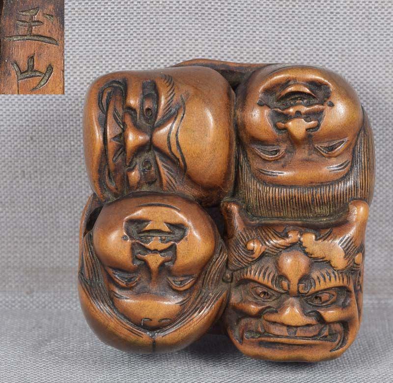 19c netsuke 7 MASKS by GYOKUZAN: 19th century boxwood netsuke carved as a group of 7 theatrical masks of an oni, a shojo, Buaku, Okame, Okina, Hyottoko and Daikoku. Wonderful piece in Japanese taste with excellent precisely carved fa