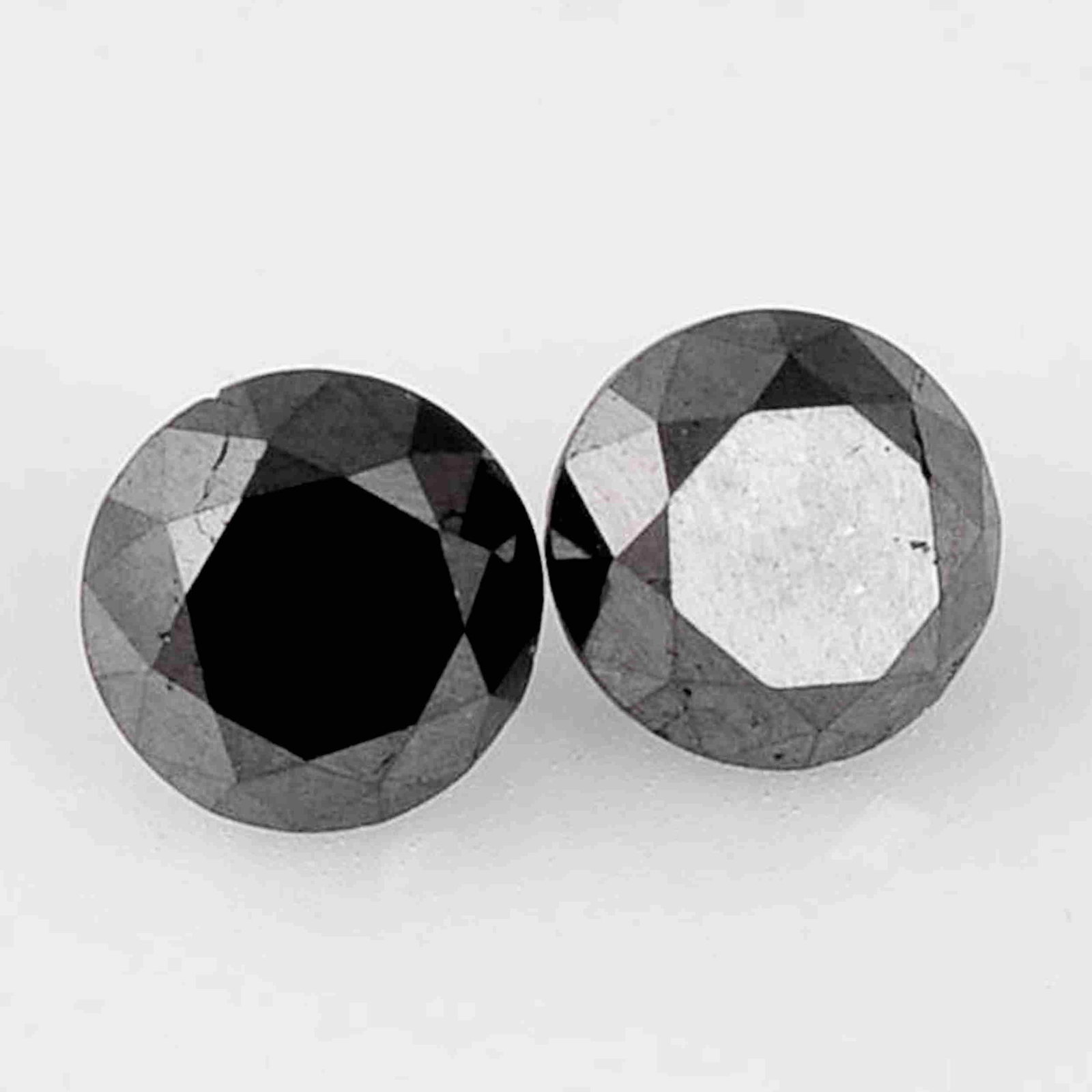 1.51 Carat Fancy Black Color Natural Round Diamond: Title: 1.51 Carat Fancy Black Color Natural Round Diamond Loose Gemstone 2 Pieces Brand: Gems Trading Center Gemstones: Diamond Carat Weights: 1.51 Size/Dimensions: 4.1H x 5.22W x 5.27L mm Reserve: $6