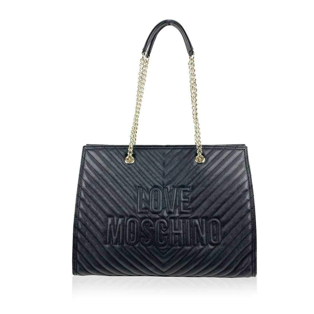 Love Moschino Black Quilled Canvas Chevron Tote: Love Moschino black leather-look canvas tote bag with chevron quilting. It features double chain and leather strap 'Love Moschino' logo on the front and magnetic button closure on top. Red satin linin