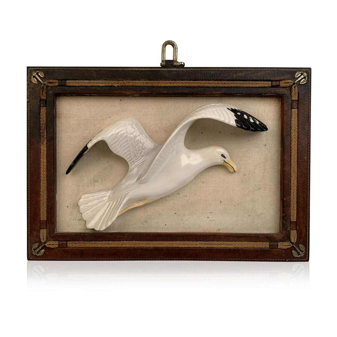 Gucci Vintage Framed Porcelain 3D Sculpture Seagull: Vintage Gucci framed three dimensional porcelain seagull wall hanging. Canvas backing with leather frame embellished with rope and 4 small metal anchors on the corners. 'Made in Italy by Gucci' tag on