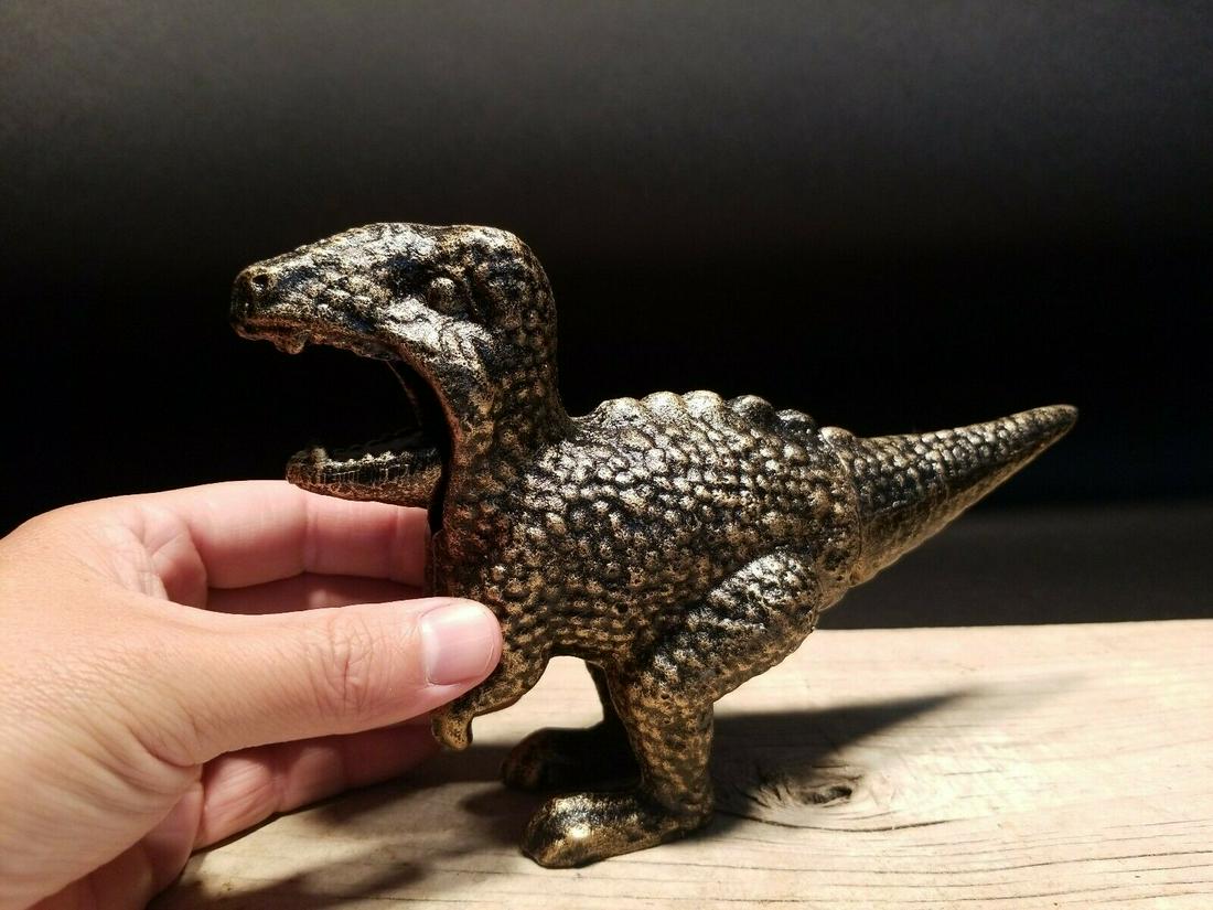 Cast Iron Dinosaur Tyrannosaurus Rex Nut Cracker: 8 1/2" long x 5 1/4" tall Full open mouth seems to be about 1 1/2"... closed is about 3/4" to 1".. hard to tell.. Such a neat all metal Dinosaur Tyrannosaurus Rex Nut Cracker. The tail acts as the nut