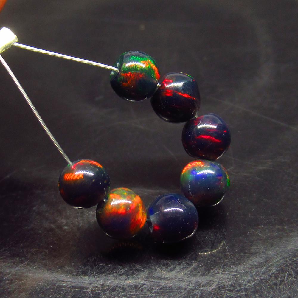 2.24 Ct Natural 7 Drilled Black Fire Opal Ball Beads: No Reserve! Title: 2.24 Ct Natural 7 Drilled Black Fire Opal Ball Beads Stone clarity:Translucent Gemstones: Natural Black Opal Beads Carat weights: 2.24 Size/Dimensions: 4.30 to 4.50 mm / 7 PC's Addi