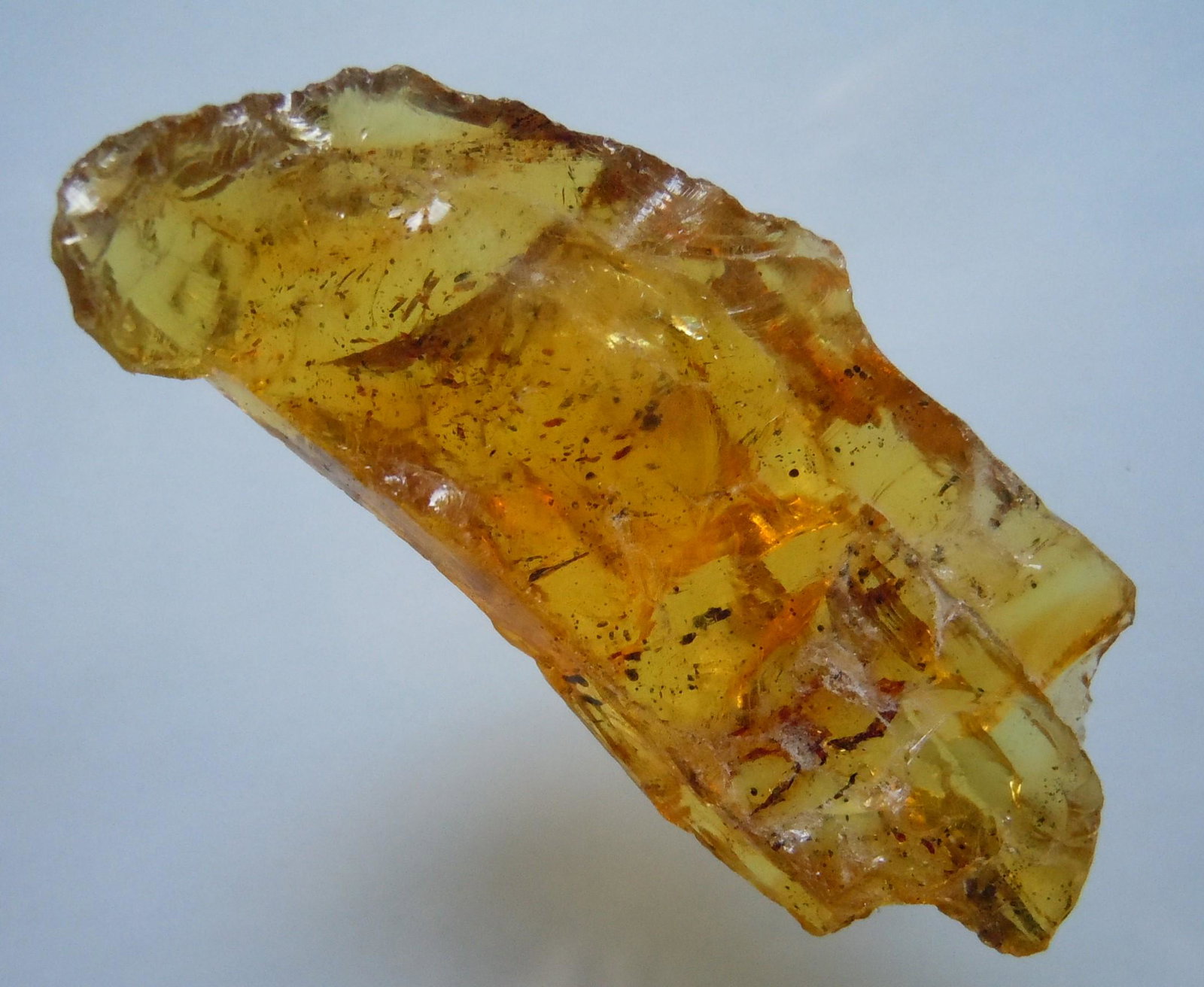 5.11 GRAM 100 MILL YEARS OLD ROUGH BURMITE AMBER: Title: 5.11 GRAM 100 MILL YEARS OLD ROUGH BURMITE AMBER Origin: Hukawang Valley, Kachin State, Myanmar Size: 4.9x2.1x1 cm / 5.11 gram Additional Information: transparent yellow burmite amber with many