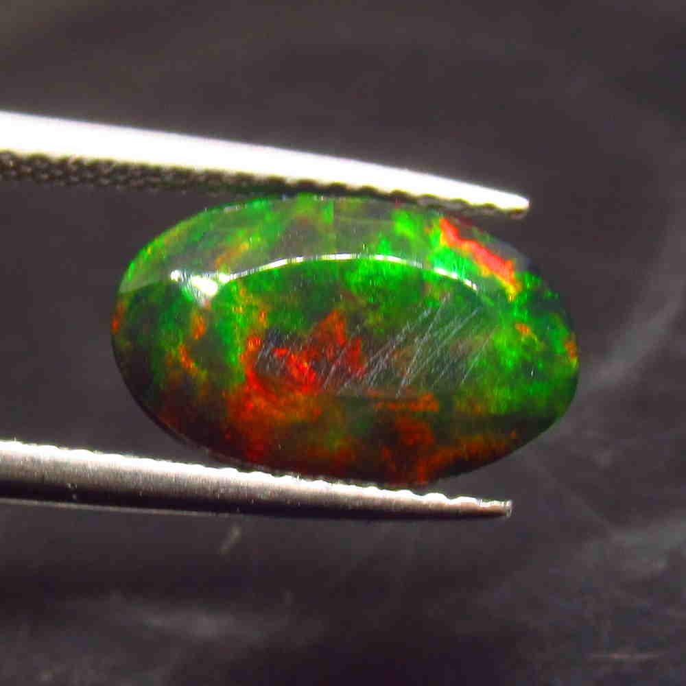 2.21 Ctw Natural Ethiopian Black Fire Opal Oval Cut: No Reserve! Title: 2.21 Ctw Natural Ethiopian Black Fire Opal Oval Cut Stone Clarity: Opaque Gemstones: Black Opal Size/Dimensions: 2.21 Carat Weights: 12.90 x 8.30 x 5.00 mm Additional Information: E