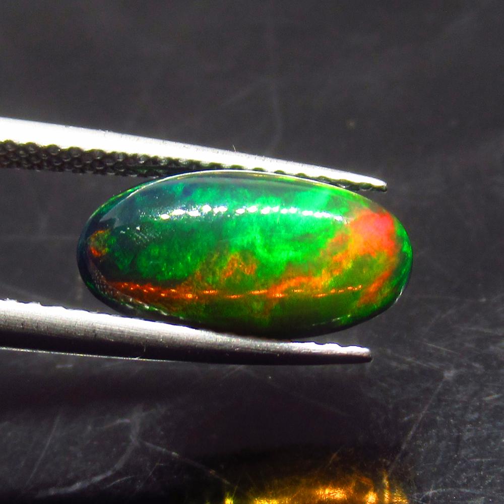 2.10 Ct Natural Ethiopian Black Fire Opal Oval Cab: No Reserve! Title: 2.10 Ct Natural Ethiopian Black Fire Opal Oval Cab Stone Clarity: Translucent Gemstones: Natural Black Opal Carat Weights: 2.1 Size/Dimensions: 13.00 x 6.90 x 4.80 mm Additional Inf