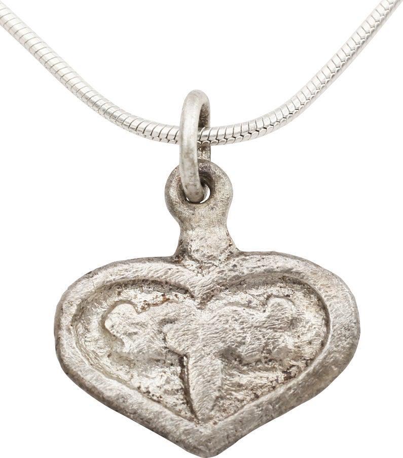 FINE VIKING HEART NECKLACE C.900-1050 AD: Over 1" height. Evolved (cusped) heart form with broad edge and intricately detailed trefoil in high relief to the field. Over 5/8" height including the suspension loop. The heart stood for bravery, f