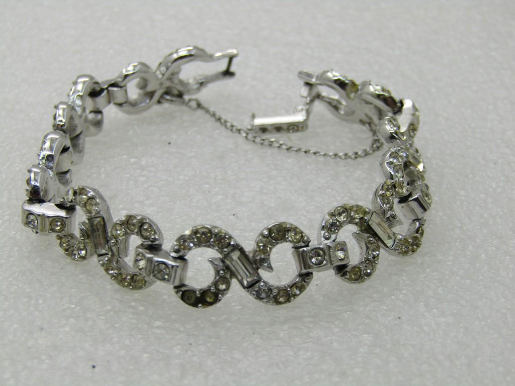 Vintage Art Deco Rhinestone Linked Bracelet, 7.25",: Vintage Art Deco Rhinestone Linked Bracelet, 7.25", Wedding Bracelet, 10.5mm wide, Safety Chain. Silver tone. Figure 8 scrolled links with round stones and baguettes. Two stones missing in the clasp b