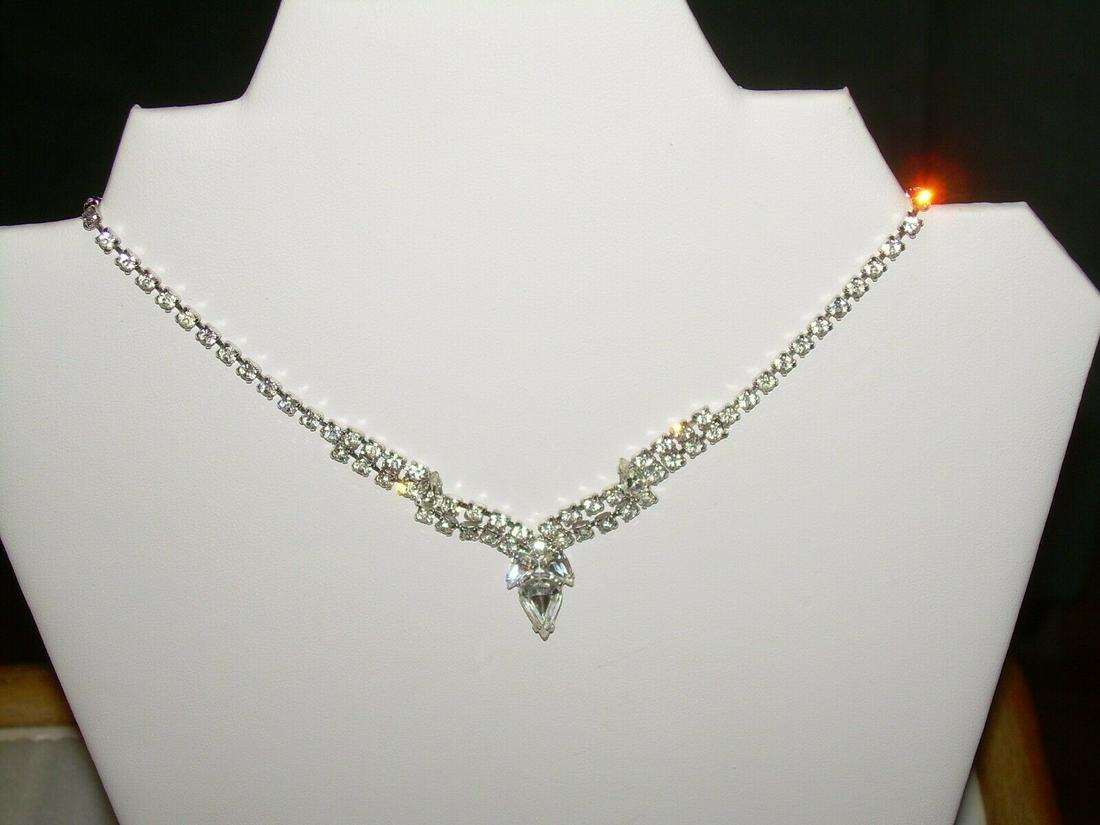 Vintage Art Deco Rhinestone Necklace 1950's Bib Choker: This vintage art deco rhinestone bib drop choker necklace is approximately 16" in length with a snap clasp. Silver tone approximately from the 1950's. B ib drop is a 2 tiered drop with an ornate V tha