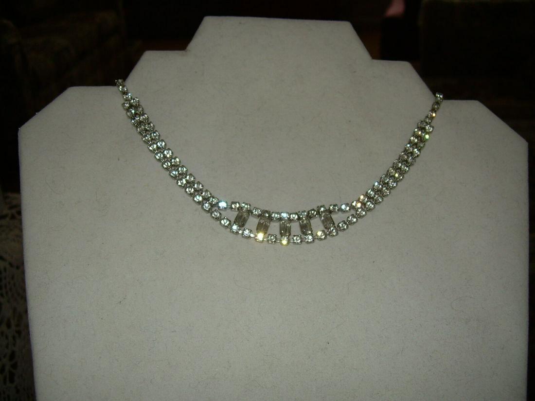 Vintage Rhinestone Choker Necklace In Silvertone W/5: Vintage and pretty rhinestone choker necklace measures 14" in length. Starting as a single strand of small round rhinestones and coming together as a double strand as they approach the center.The cent