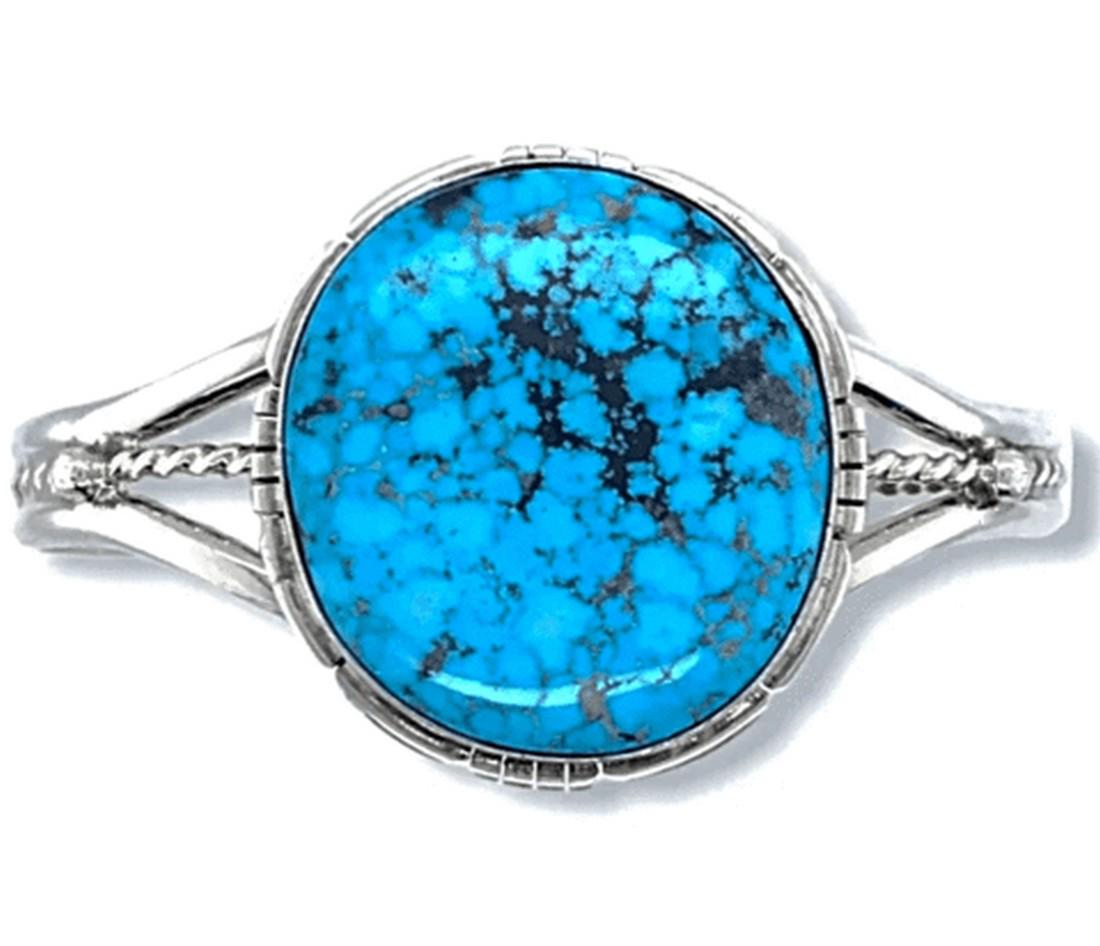 Navajo Kingman Turquoise Bracelet With Silver Twist: Measurements: Top/Front Design: 1 3/8 tall, 2 7/8" wide Stone Size: 1 1/4" tall, 1 1/8" wide Inside Circumference: 5 1/4" Gap: 1 1/4" (adjustable) Band Width: 1/4" Item#: BR148B Metal: Sterling Silver