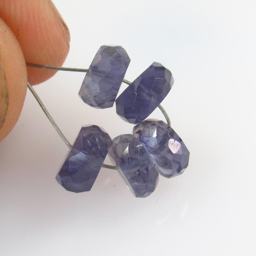 7.84 Ct Natural 5 Drilled Iolite Round Beads: No Reserve! Title: 7.84 Ct Natural 5 Drilled Iolite Round Beads Stone Clarity: Transparent Gemstone: Natural Iolite Beads Carat Weight: 7.84 Size/Dimensions: 7.10 - 7.60 mm / 5 Pc's Additional Informa