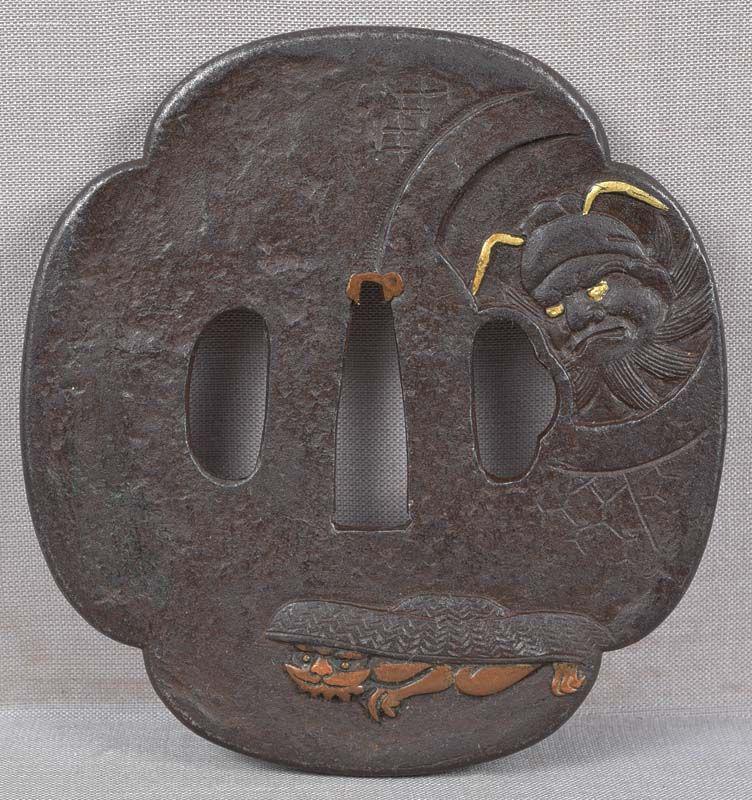 18c Japanese sword TSUBA Shoki & ONI ex St. John: 18th century good size Japanese sword iron tsuba with raised and inlaid decoration of Shoki the Demon Queller looking through a round window at a terrified oni (mischievous little demon) hiding under 
