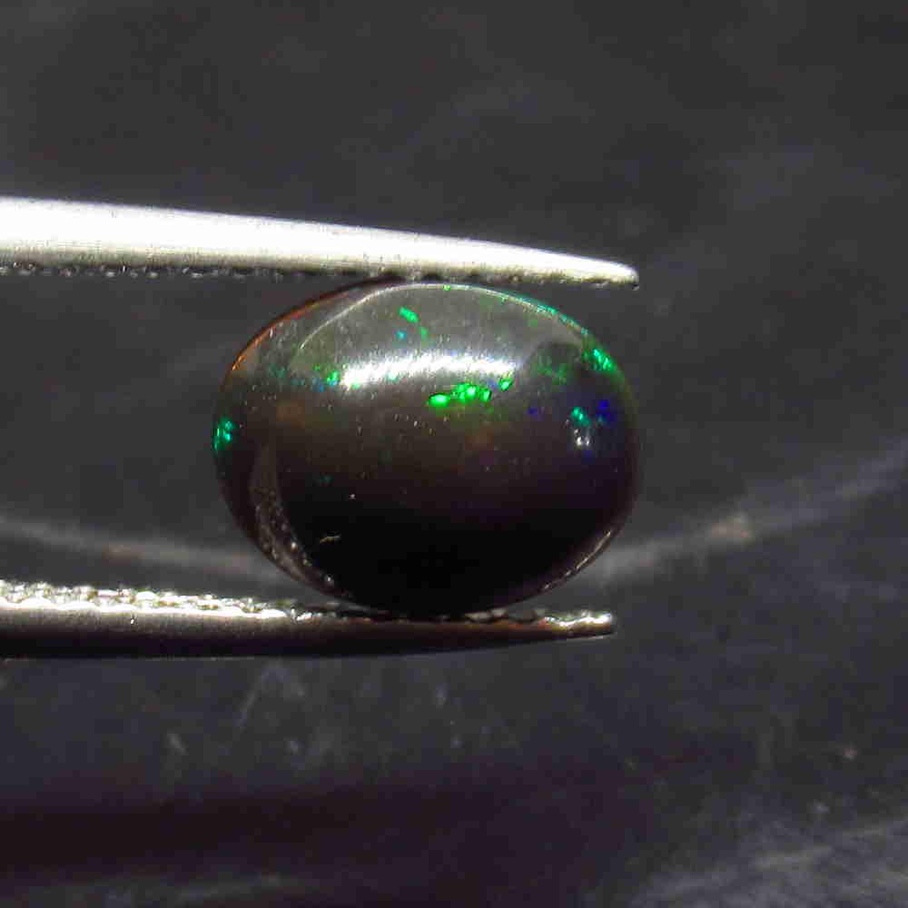 0.95 Ctw Natural Ethiopian Black Fire Opal Oval Cab: No Reserve! Title: 0.95 Ctw Natural Ethiopian Black Fire Opal Oval Cab Stone Clarity: Translucent Gemstone: Black Opal Carat Weight: 0.95 Size/Dimensions: 8.80 x 6.90 x 3.80 mm Additional Information:
