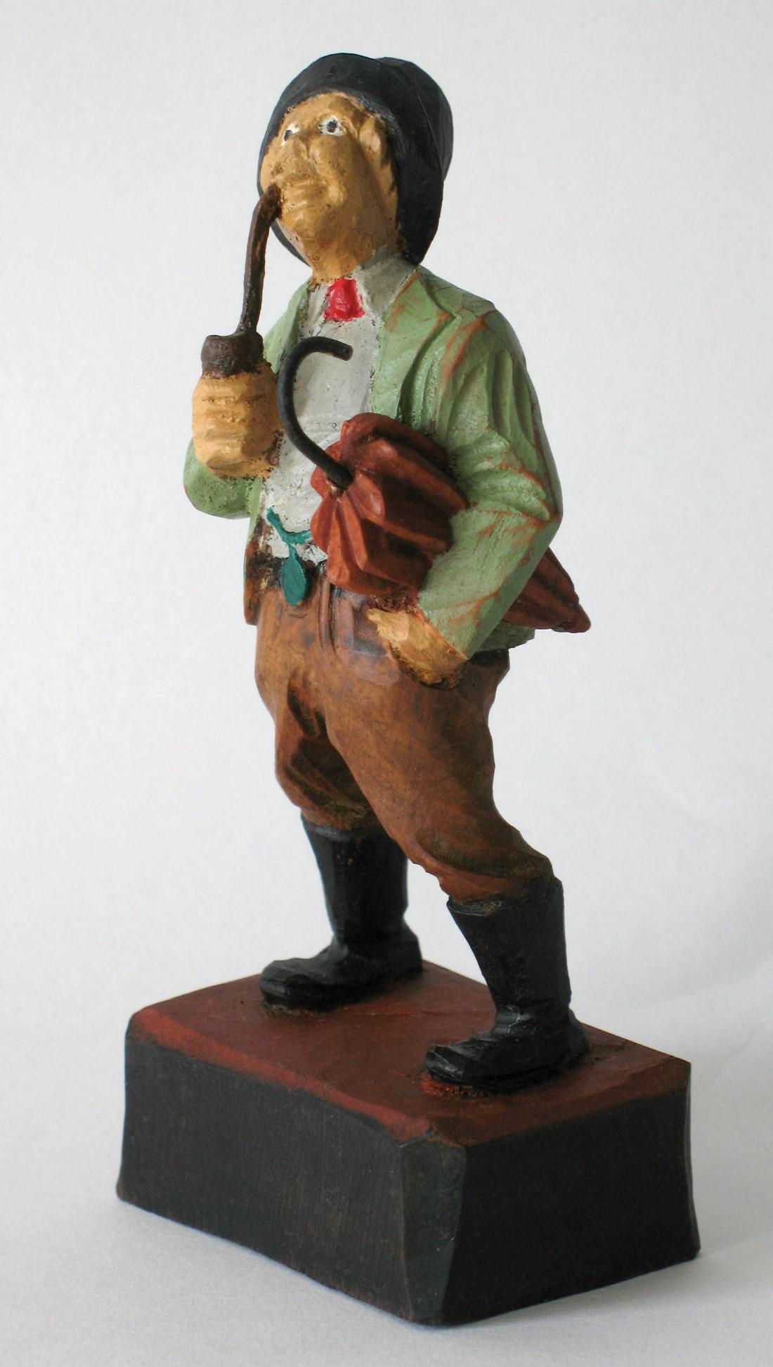 Vintage folk art wood carving.: Title: Vintage folk art wood carving. Date/Period: 1930's Dimension: 4 1/2" tall Additional Information: Vintage folk art wood carving of a man smoking his pipe and carrying his umbrella. Shipping: Do