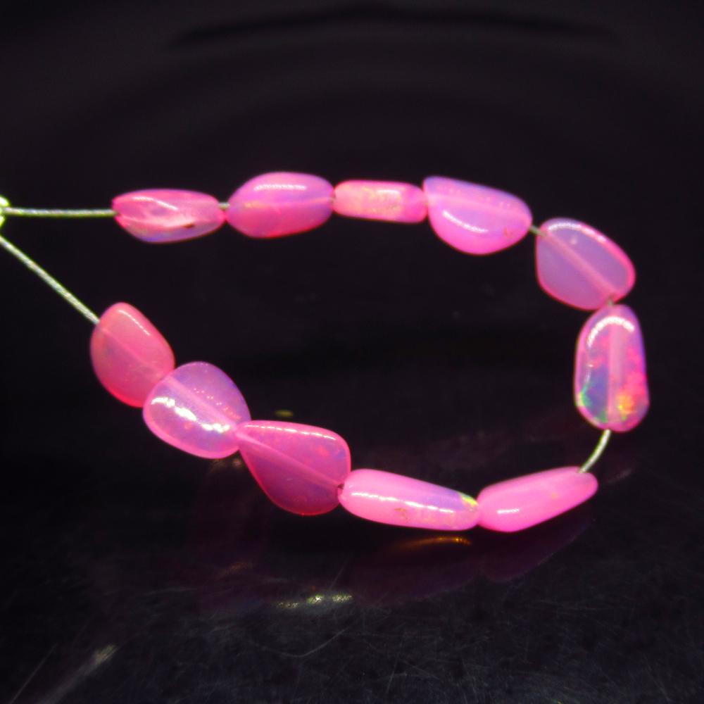 3.08 Ct Natural 11 Drilled Pink Fire Opal Beads: No Reserve! Title: 3.08 Ct Natural 11 Drilled Pink Fire Opal Beads Stone Clarity:Translucent Gemstone: Natural Pink Opal Beads Carat Weight: 3.08 Size/Dimensions: 4.4x4.3 to 7.5x4.0 mm / 11 PC's Addit