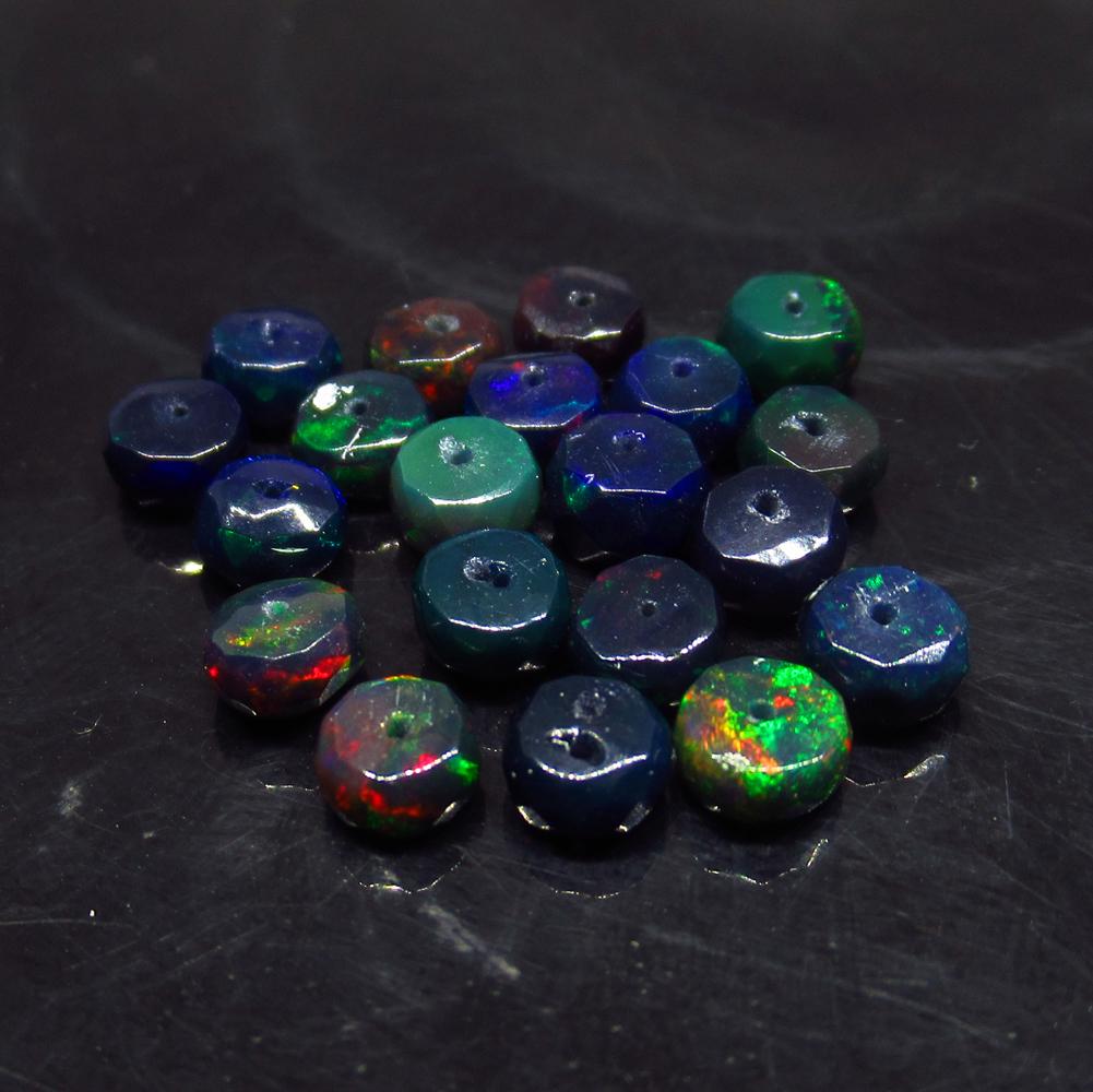 5.57 Ct Natural 19 Drilled Faceted Black Fire Opal: No Reserve! Title: 5.57 Ct Natural 19 Drilled Faceted Black Fire Opal Beads Stone Clarity:Translucent Gemstone: Natural Black Opal Beads Carat Weight: 5.57 Size/Dimensions: 4.40 to 4.90 mm / 19 PC's A