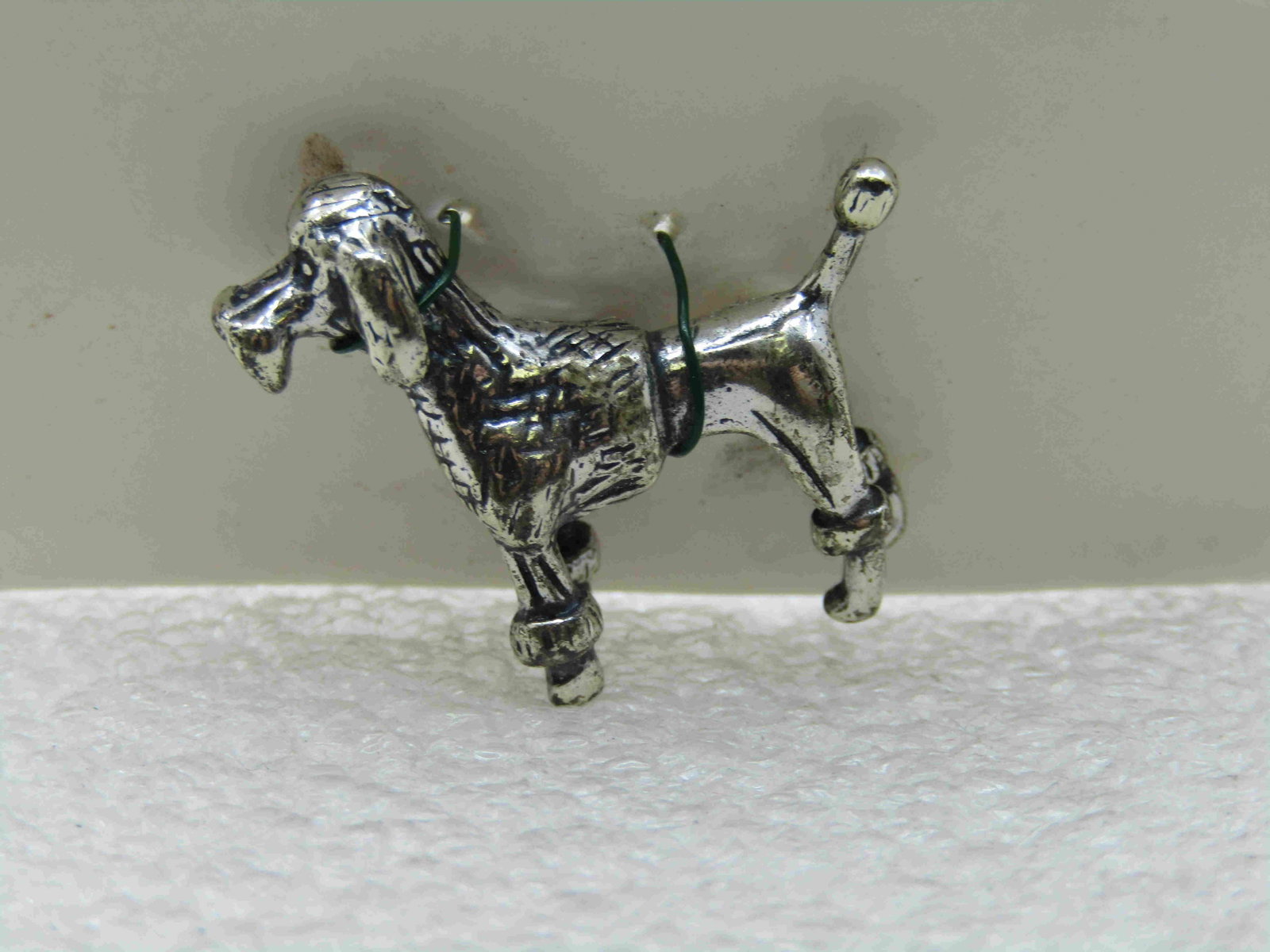 Vintage .800 SIlver Poodle Minature Figurine, 1",: Vintage .800 SIlver Poodle Miniature Figurine,, 1". It is marked .800 and marked with a maker's mark on it's underside. Little puffy ankles and vest cut with fuzzy muzzle. Erect tail with pom pom tip.