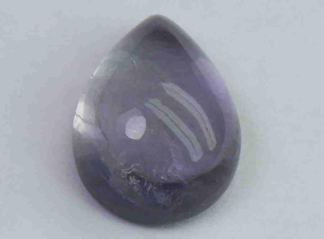 2.22 Cts Natural Iolite: No Reserve! Gemstone: Natural IoliteOrigin: India Weight: 2.22 Carats Measurements: 10x7.3x4.5 mm Shape / Cut: Pear Cabochon Colour: Violet Blue Transparency: transparent Clarity: Some Natural inclusi