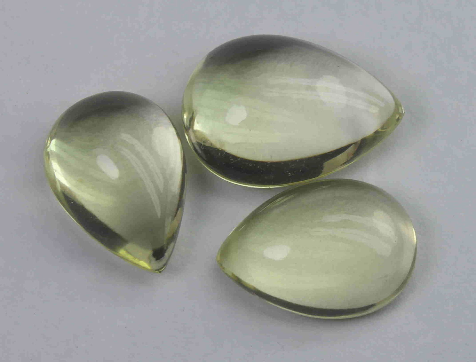 11.98 Ct Natural Lemon Quartz Lot: No Reserve! Gemstone : Natural Lemon QuartzWeight : 11.98 CaratsDimensions : 13.9x10.2x5.8 mm ,12.4x8.8x4.4 mm , 12.2x8.6x5.4 mmShape : Pear CabochonNumber of Stone : 3Colour : Greenish Yellow Origin 