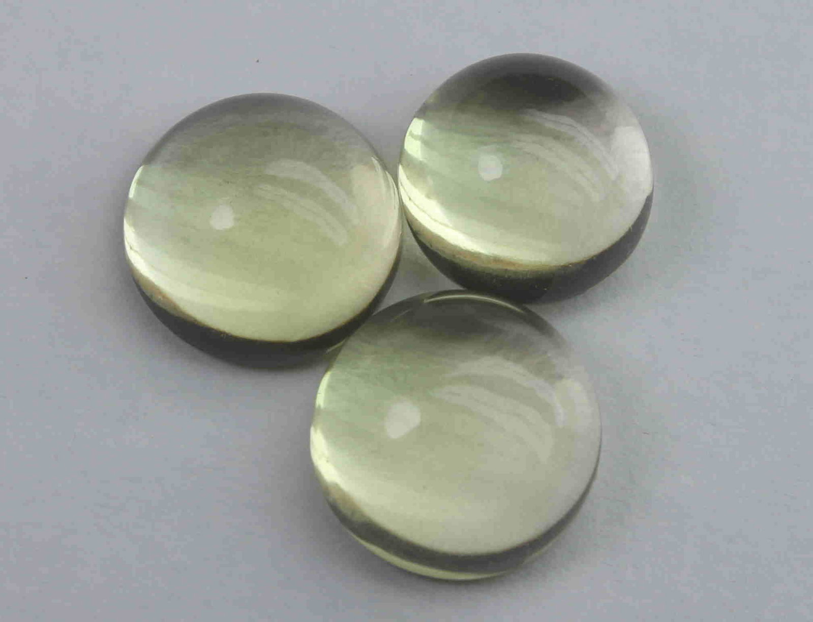 10.66 Ct Natural Lemon Quartz Lot: No Reserve! Gemstone : Natural Lemon QuartzWeight : 10.66 CaratsDimensions : 9.9-9.8x5.3 mm , 9.7-9.7x5.2 mm , 8.9-8.9x5.7 mmShape : Round CabochonNumber of Stone : 3Colour : Greenish Yellow Origin : 