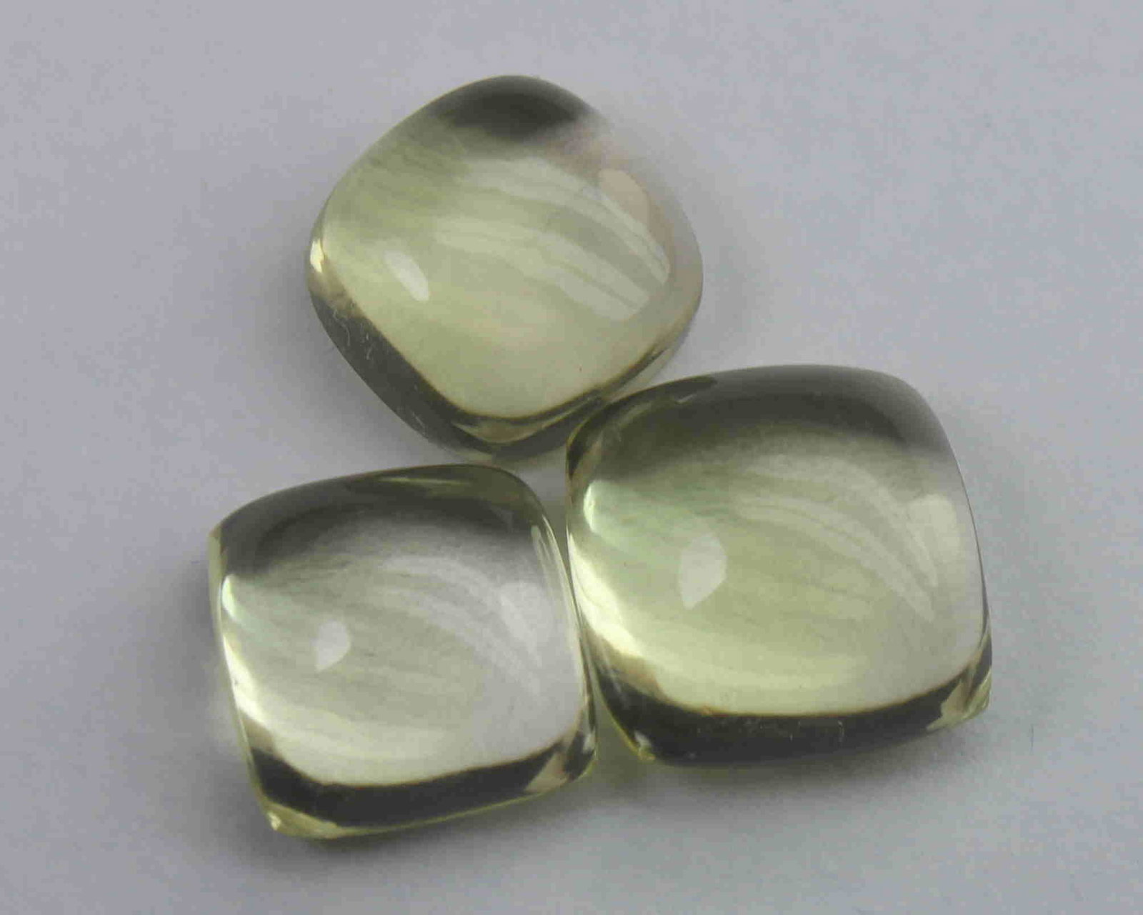 11.89 Ct Natural Lemon Quartz Lot: No Reserve! Gemstone : Natural Lemon QuartzWeight : 11.89 CaratsDimensions : 10.2x10.2x6 mm ,8.9x8.8x5.3 mm , 9.1x9x4.5 mmShape : Square Cushion CabochonNumber of Stone : 3Colour : Greenish Yellow Ori