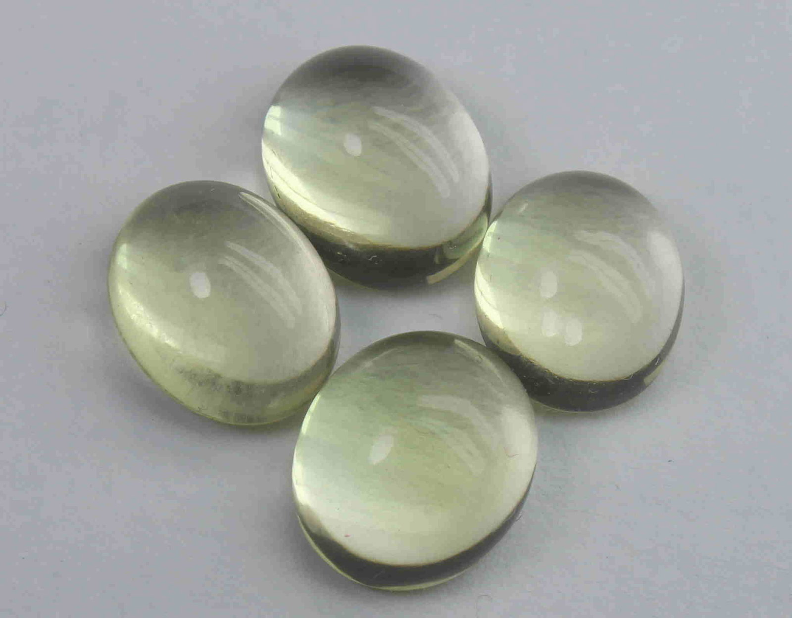 12.28 Ct Natural Lemon Quartz Lot: No Reserve! Gemstone : Natural Lemon QuartzWeight : 12.28 CaratsDimensions : 10.3x8.8x5.2 mm - 9.7x8x4.6 mmShape : Oval CabochonNumber of Stone : 4Colour : Greenish Yellow Origin : AfricaTransparency: