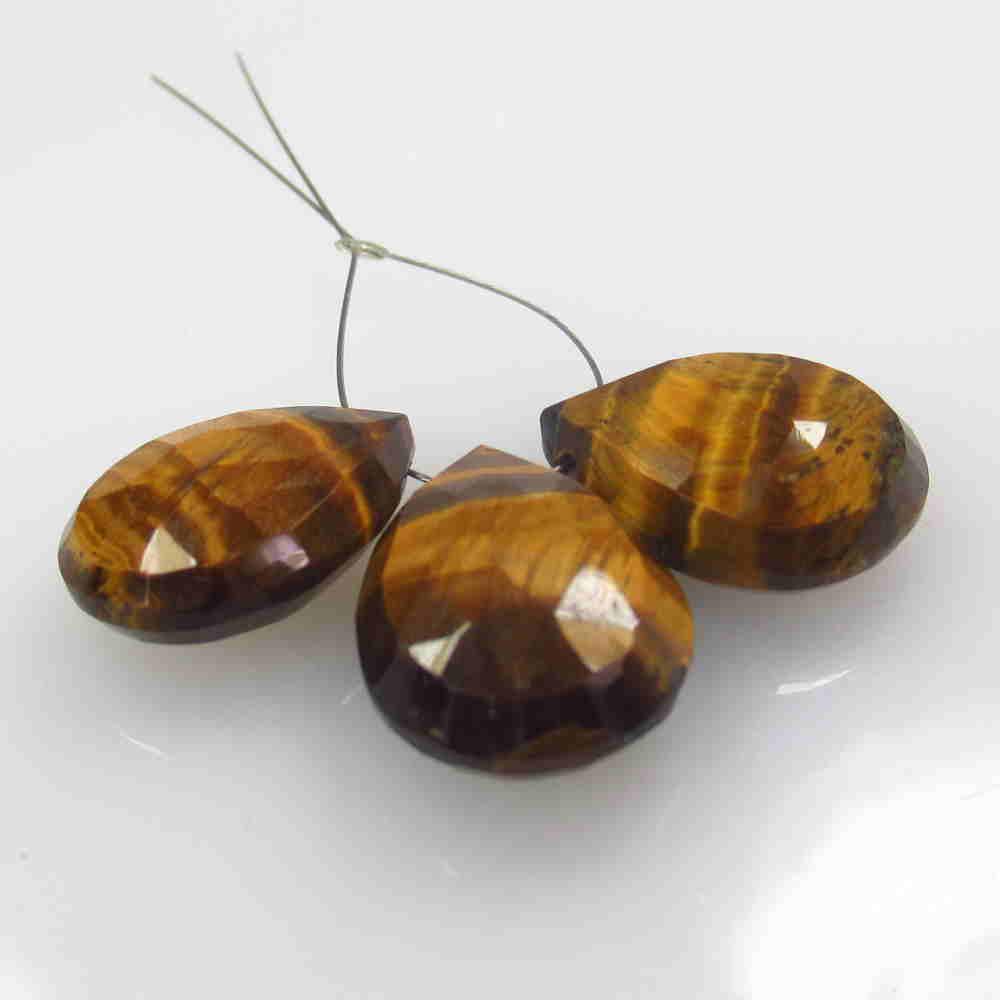 25.46 Ctw Natural 3 Drilled Tiger's Eye Pear Beads: No Reserve! Title: 25.46 Ctw Natural 3 Drilled Tiger's Eye Pear Beads Color/Clarity: Opaque Gemstone:Tiger's Eye Beads Carat Weight: 25.46 Size/Dimensions: 16.2x12.0 to 18.0x12.6 mm / 3 PC's Additiona