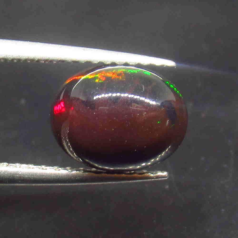 1.57 Ctw Natural Ethiopian Black Fire Opal Oval Cab: No Reserve! Title: 1.57 Ctw Natural Ethiopian Black Fire Opal Oval Cab Color/Clarity: Translucent Gemstone:Black Opal Carat Weight: 1.57 Size/Dimensions: 9.10 x 7.20 x 4.50 mm Additional Information: 