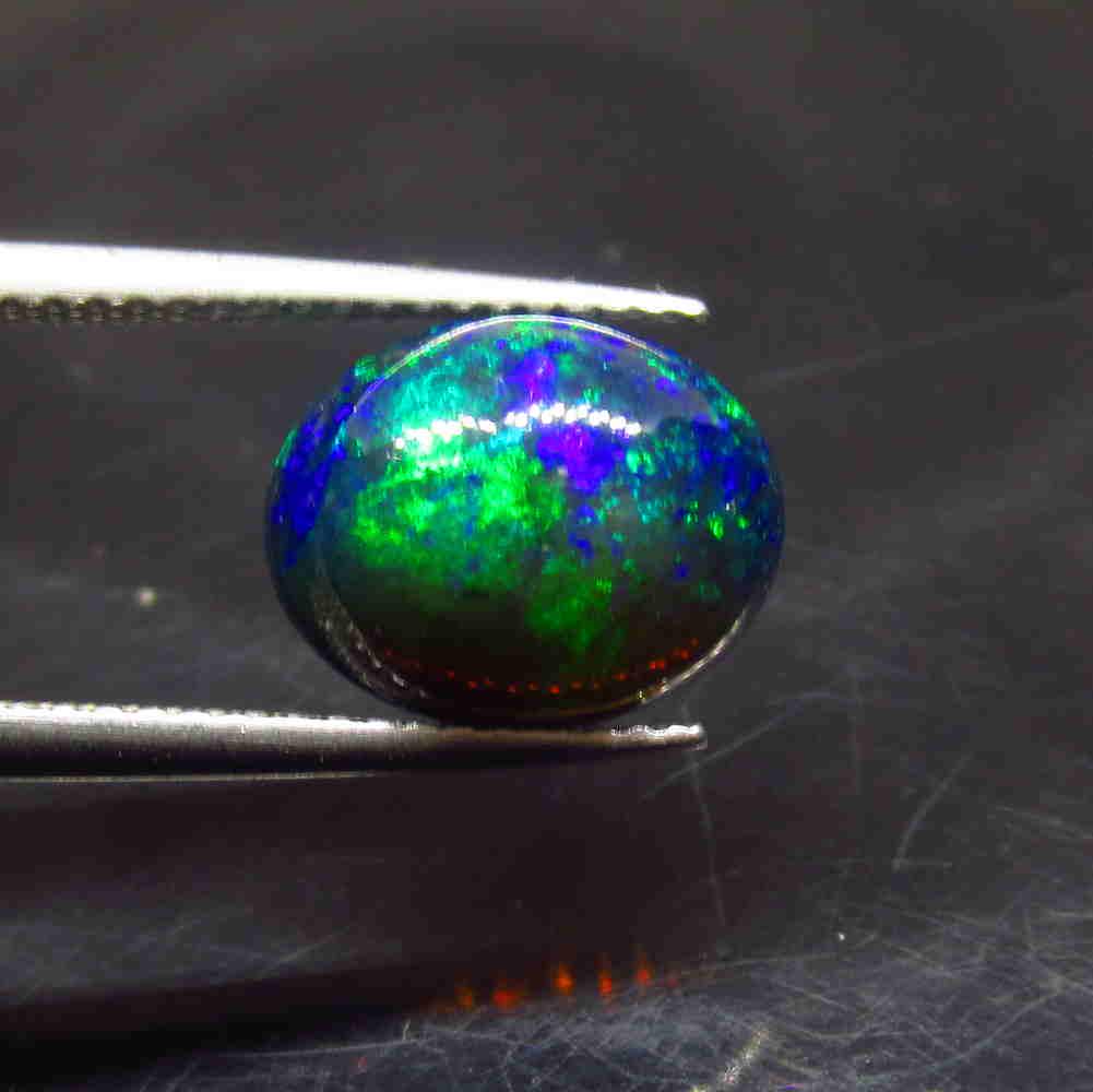 2.50 Ctw Natural Ethiopian Black Fire Opal Oval Cab: No Reserve! Title: 2.50 Ctw Natural Ethiopian Black Fire Opal Oval Cab Color/Clarity: Translucent Gemstone:Black Opal Carat Weight: 2.50 Size/Dimensions: 11.00 x 9.00 x 5.00 mm Additional Information: