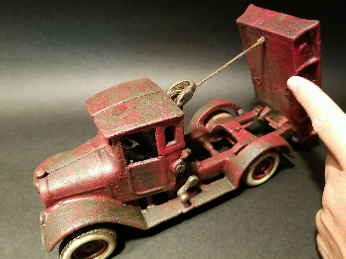 Cast Iron Red Toy Tow Truck Flat bed Car Rubber Wheels: 10 1/4" Long x 3 1/4" Wide 4 1/8" Tall Such a neat reproduction cast iron tow truck! As you can see this heavy cast iron truck was wonderfully hand painted and distressed to look original. The car is 
