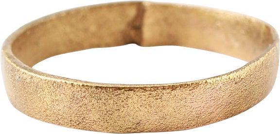 VIKING WEDDING RING C.850-1050 AD, SIZE 3 ¾: Late 9th-early 11th century AD. Gilt bronze, size 3 3/4 for the small finger as was the custom. Narrowband 2.7mm, expanding to 2.8mm at the top. Low rounded face. Surface textured from burial. Profess