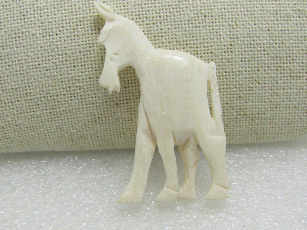 Carved Horse Pendant/Bead White, 2" by 1.25": Carved Horse Bead, Faux or Bovine/Ox bone - white to ivory colored. It is 2" tall and and 1.25" wide. The horse has nice detail on it mane and tail. It has a bead hole on its back to insert an eyelet 