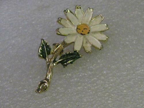 Vintage Brooch, Smiling Daisy & Stem, Gold Tone White: Vintage brooch - 1960's smiling daisy that is 1.75" tall and about 1" wide with white enamel petals and green leaves and a peach tone face with a little smile. There is some wear on the tips of the wh