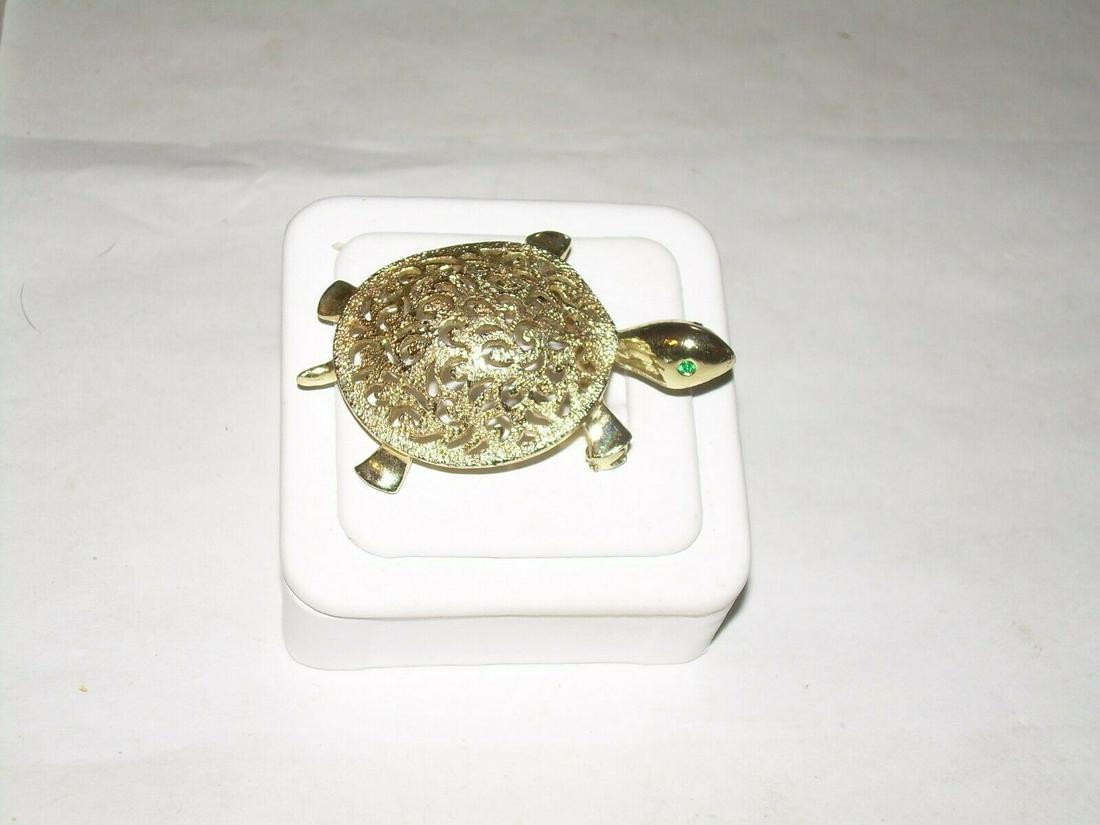 Vintage Gold Tone Turtle Brooch - Filigree Shell, Green: Vintage gold tone turtle brooch was purchased at a PA estate sale. The shell is a filigree design. The feet, tail and head are all solid. The eyes are an emerald green rhinestones.The brooch is 2.25" 