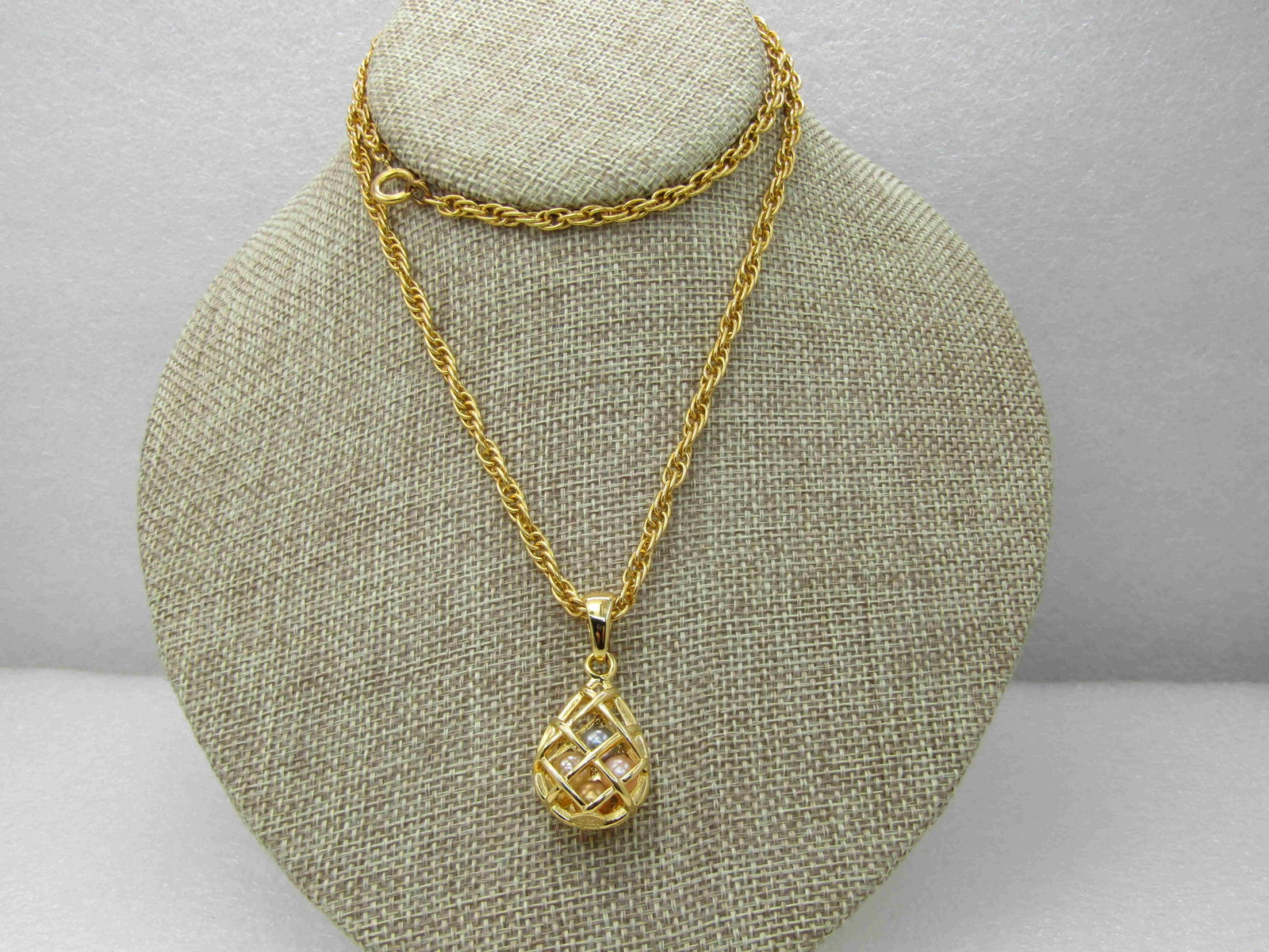 Vintage Joan Rivers Caged Faux Pearl Necklace, 24": Vintage Joan Rivers Caged Faux Pearl Necklace, 24"- gold tone teardrop pearl cage with swing bail with four faux Tahitian pearls in pink, gray, champagne, white tht are appx. 6mm (cannot measure due t