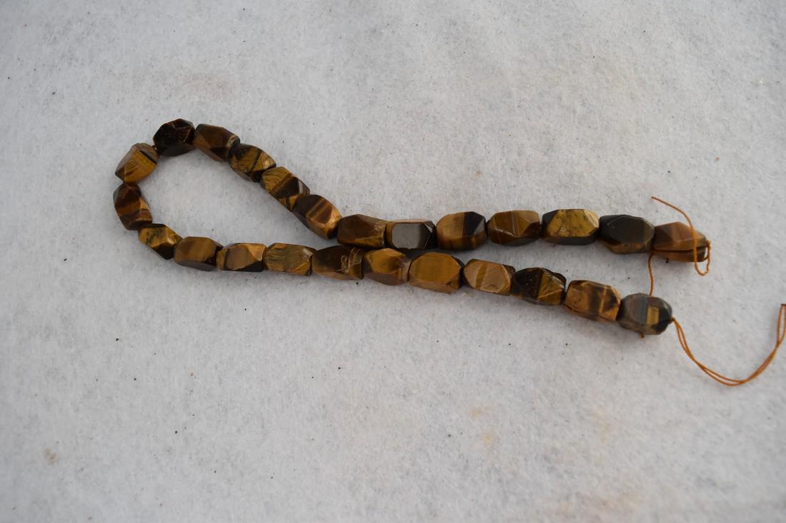 16" Stand of Polished Tiger Eye Beads: 16" Stand of Polished Tiger Eye Beads Reserve: $5.00 Shipping: Domestic: Flat-rate of $10.00 to anywhere within the contiguous U.S. International: Foreign shipping rates are determined by destination.