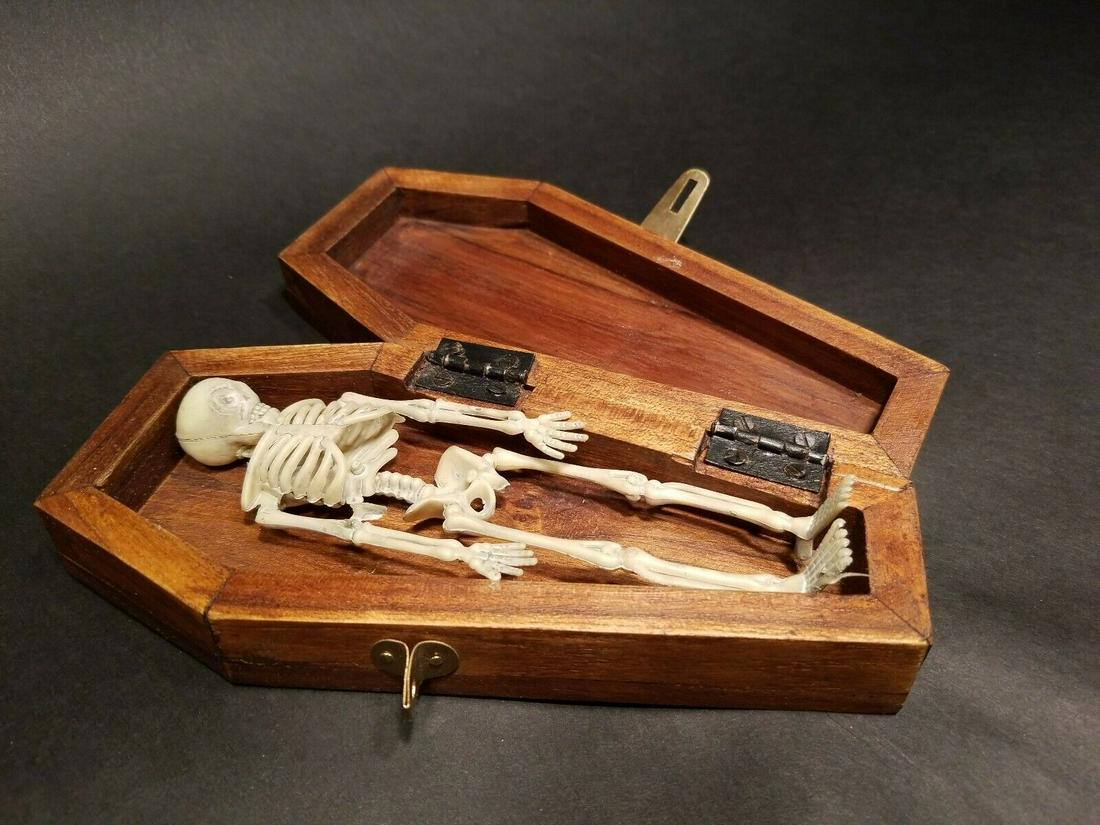 Miniature RIP Coffin w Skeleton: 7" Long x 3 1/4" Wide x 1 3/4" High Such a neat antique style item! The hardwood box/coffin has RIP engraved on the top of the lid. The latch and hinges on the coffin are brass aged to look old. On th
