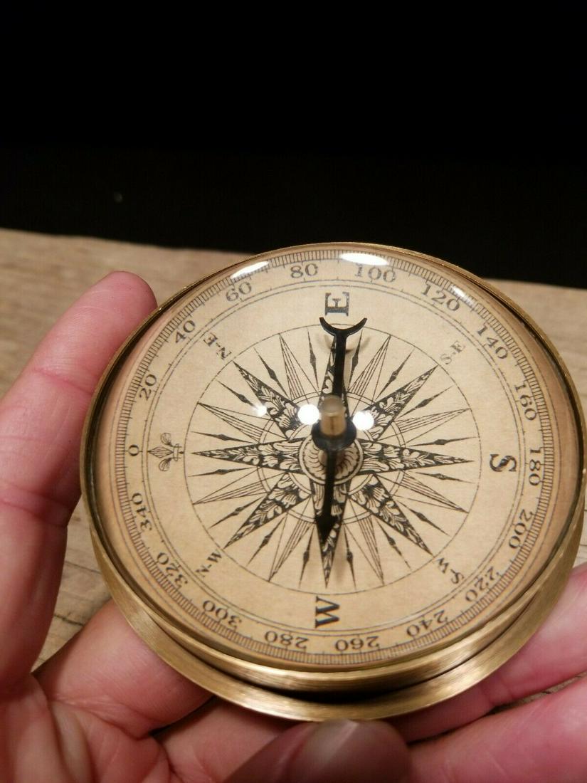 Brass Magnifying Glass Navigational Compass: 3 3/8" wide x 1 1/4" tall Nice reproduction of an antique compass. Great heavy quality piece made to look like an original! Reserve: [$25.00 Shipping: Domestic: Flat-rate of $7.00 to anywhere within t