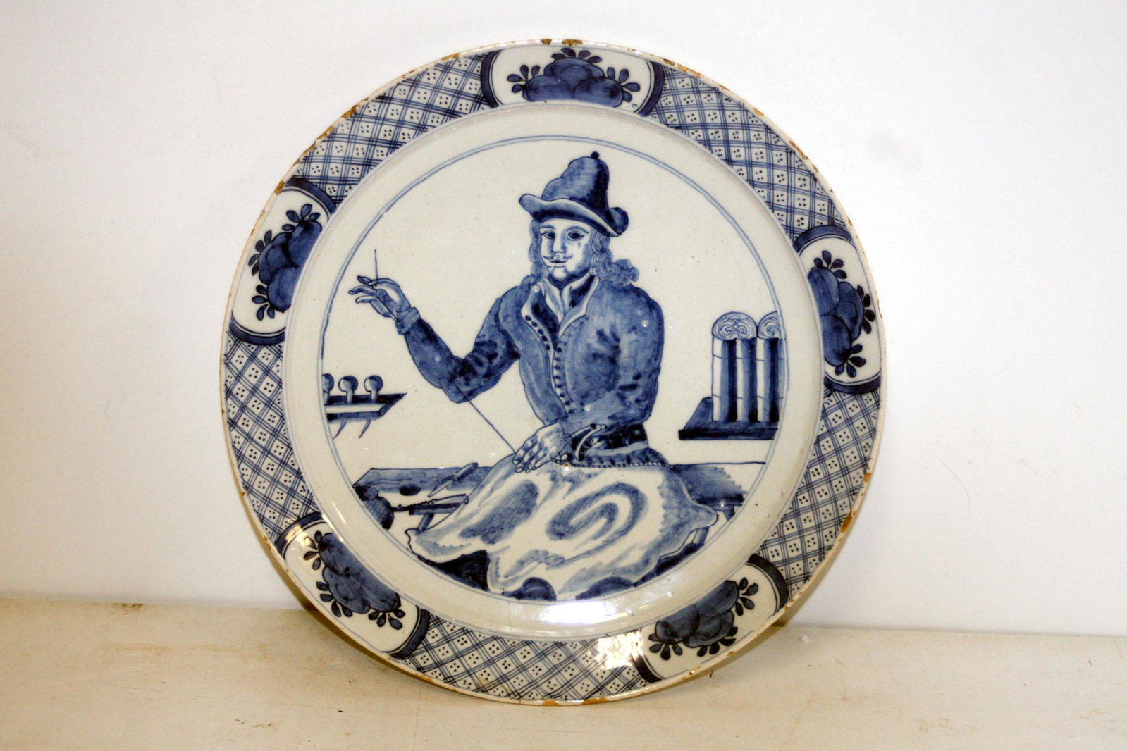 A fine scarce Dutch delft occupational plate by Ary: Title: A fine scarce Dutch delft occupational plate by Ary Jironomous Van der Kloot Date/Period: c. 1710 Dimensions: 10" diam Provenance/Additional Info:with a central decoration of a sail maker Shipp