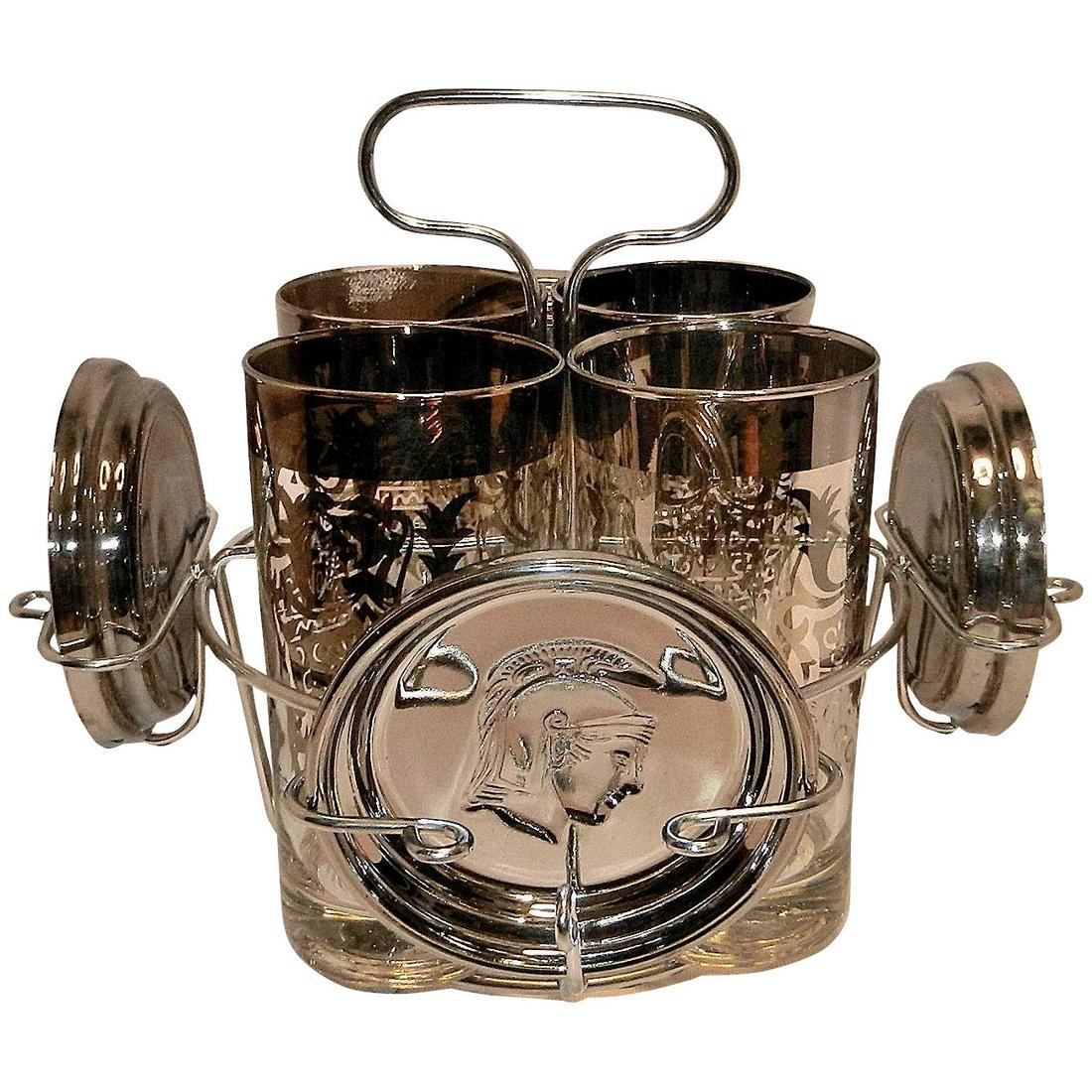 Mid Century Kimiko Guardian Crest Silver Highball and: This Mid Century Kimiko Guardian Crest Highball and Coaster Barware Set signed Kimiko is in very good to excellent condition. One glass has very wear on the lip (shown in photo). Each tumbler is decor