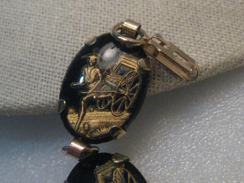 Vintage Rickshaw Repousse Scene Bracelet,: Vintage Chinese Rickshaw Scene Bracelet, black and gold tone, repousse raised Chinese man pulling a rickshaw which is under a clear plastic layer. The links are 1" long and 1/2" wide, ovals, prong-set