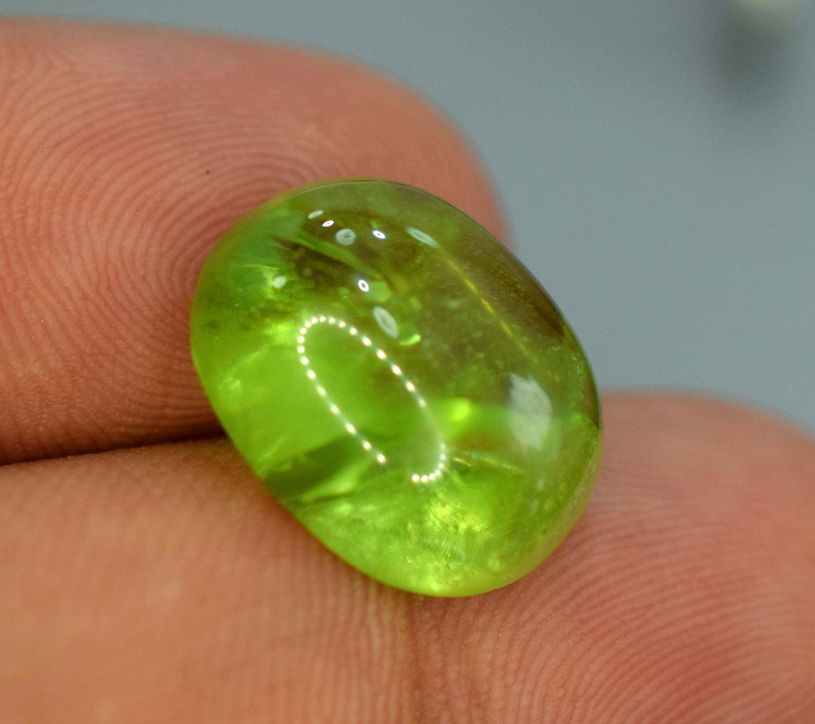 12.25 carats Attractive Juicy Olivine Color Peridot: 12.25 carats Attractive Juicy Olivine Color Peridot Polished Cabochon From Supat Mines Paksiatan Weight : 12.25 carats Dimensions - 15.5*13*6.5 mm Origin : Supat Mine Pakistan Treatment Natural Color 