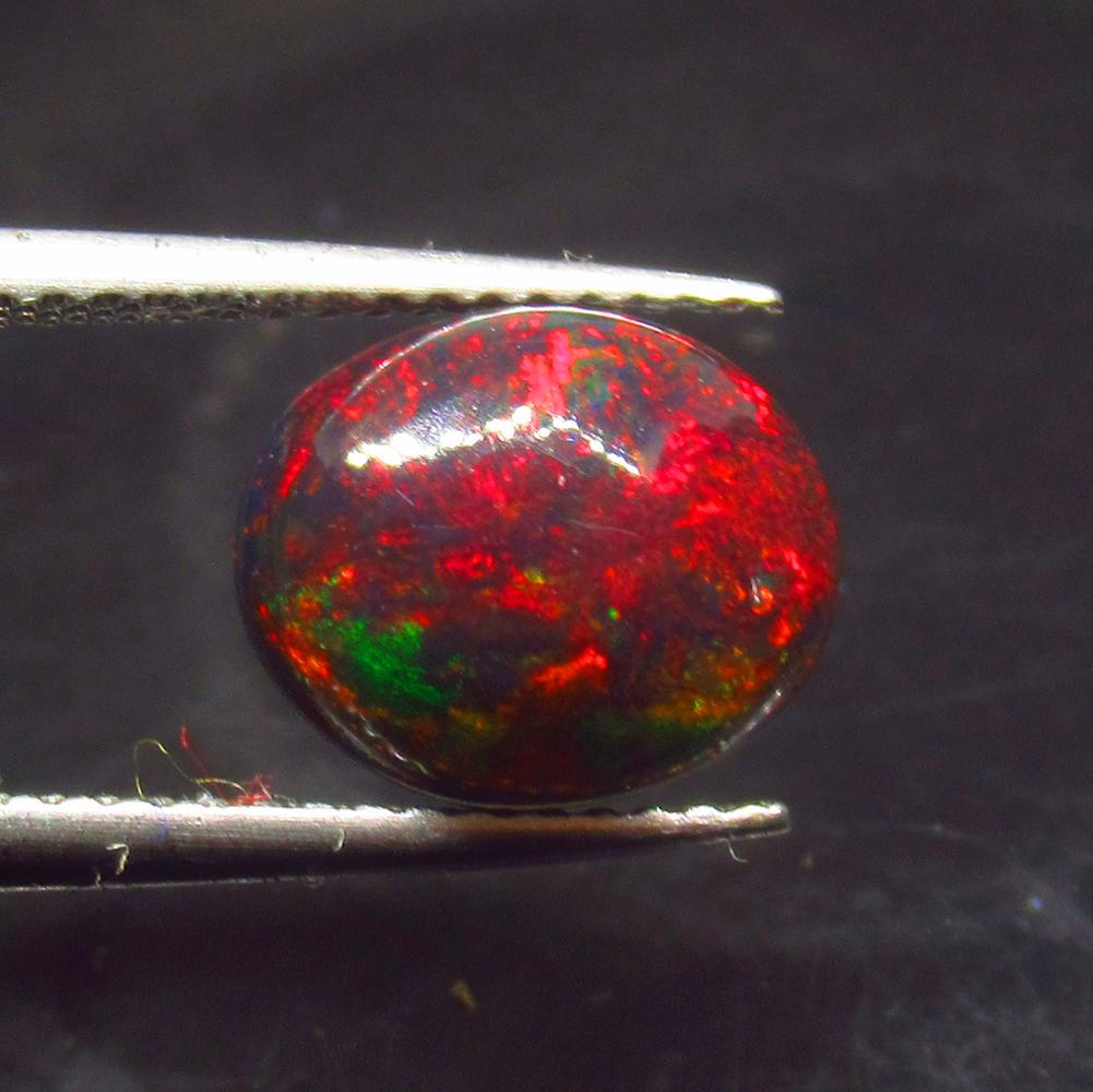 1.77 Ct Natural Ethiopian Black Fire Opal Oval Cab: Title: 1.77 Ct Natural Ethiopian Black Fire Opal Oval Cab Stone Clarity: Translucent Gemstones: Natural Black Opal Carat Weights: 1.77 Size/Dimensions: 10.20 x 8.60 x 4.00 mm Additional Information: E