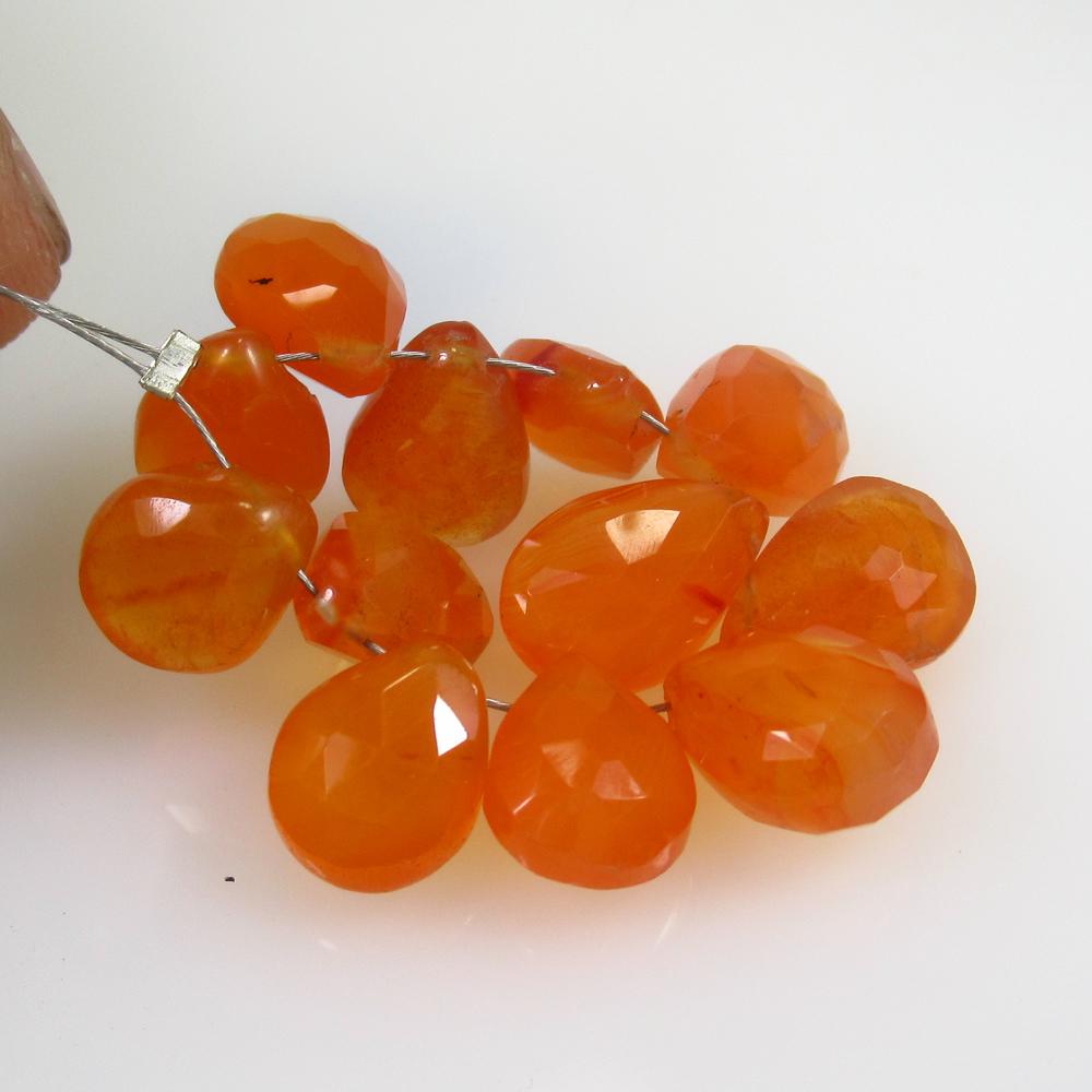 31.72 Ct Natural 12 Drilled Carnelian Pear Beads: No Reserve! Title: 31.72 Ct Natural 12 Drilled Carnelian Pear Beads Stone Clarity: Semi-Transparent Gemstones: Natural Carnelian Beads Carat Weights: 31.72 Size/Dimensions: 9.3x8.0 - 11.3x7.6 mm / 12 