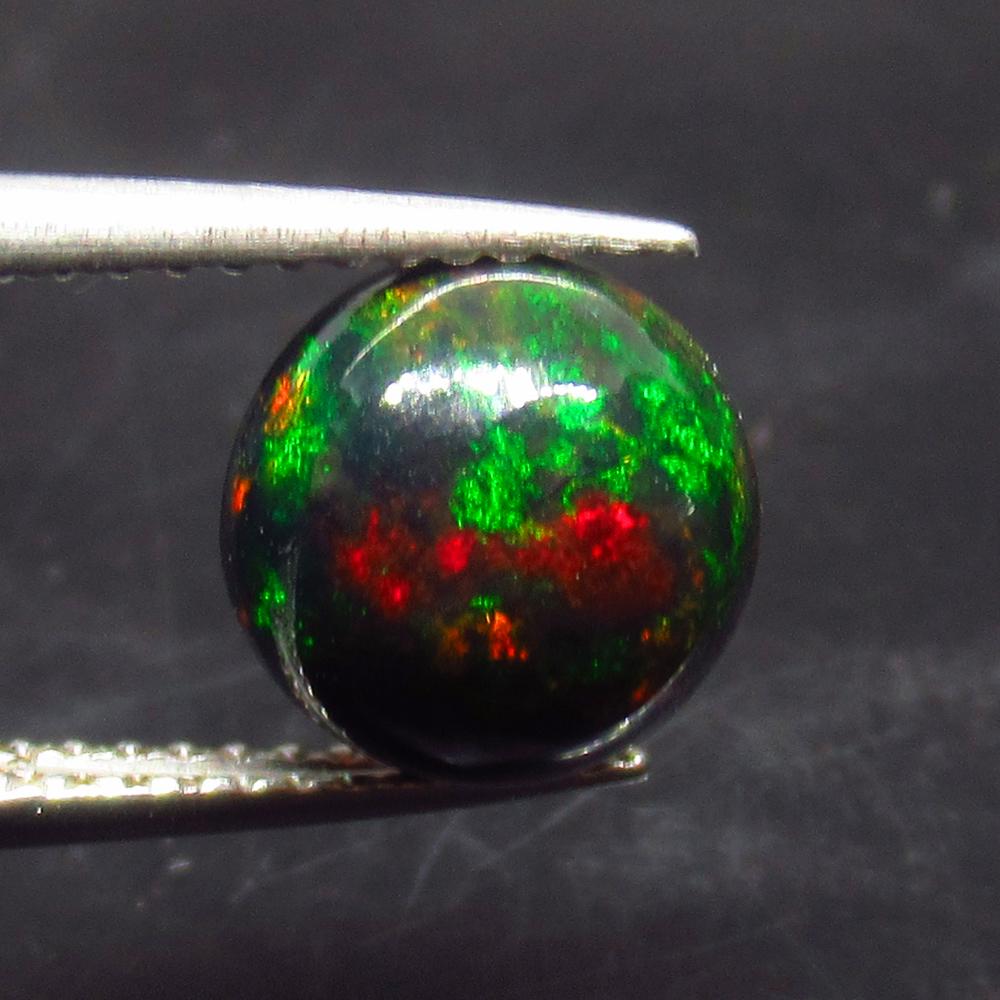 1.84 Ct Natural Ethiopian Black Fire Opal Round Cab: No Reserve! Title: 1.84 Ct Natural Ethiopian Black Fire Opal Round Cab Stone Clarity: Translucent Gemstones: Natural Black Opal Carat Weights: 1.84 Size/Dimensions: 8.40 x 8.40 x 5.40 mm Additional In
