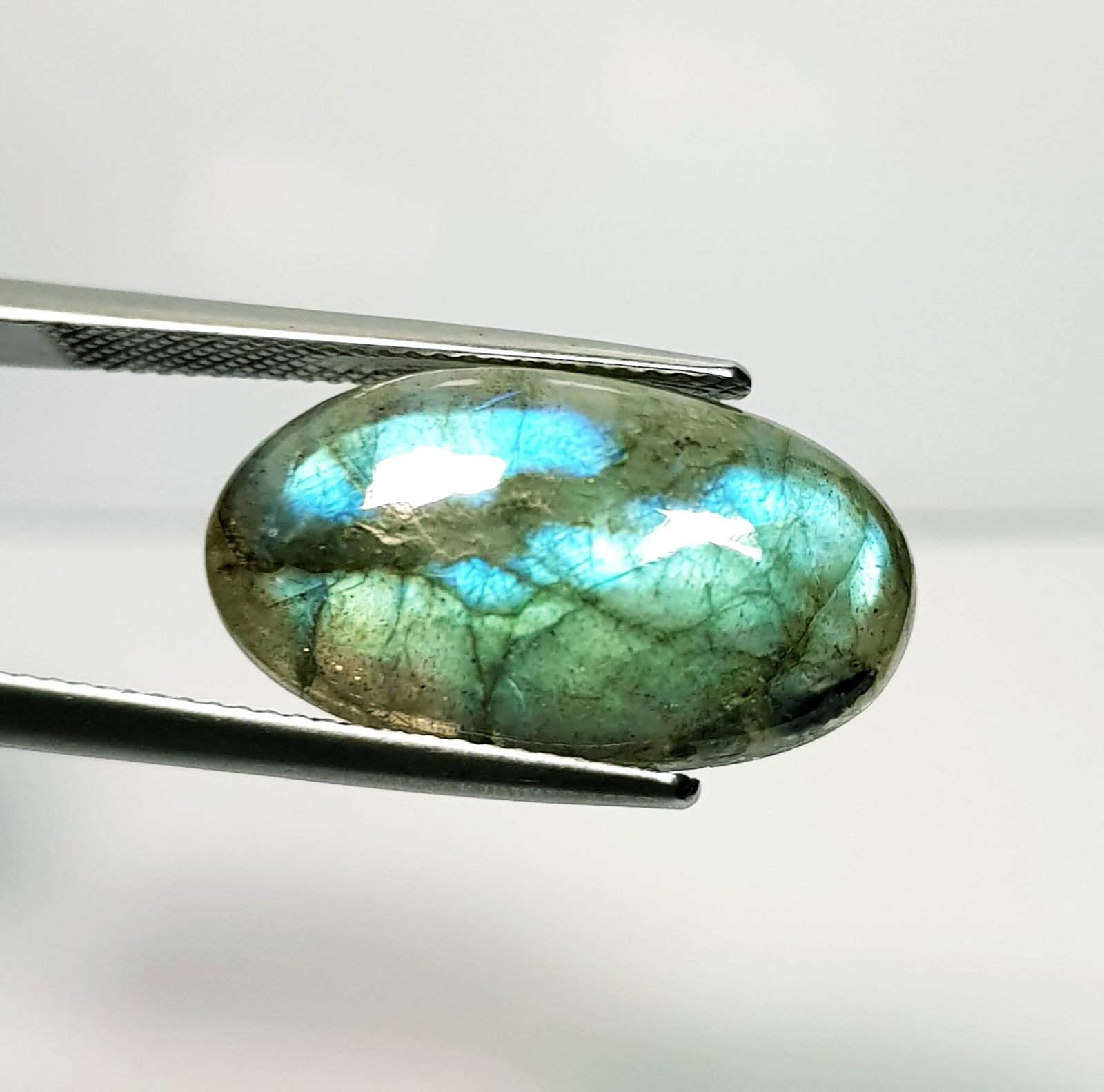 10.72 ct Natural Labradorite: No Reserve! Title: 10.72 ct Natural Labradorite Color/Clarity: Opaque Carat Weight: 10.72 Size/Dimensions: 21.35 x 11.90 x 4.90 Additional Information: Oval - USA Shipping: Domestic: Flat-rate of $7.