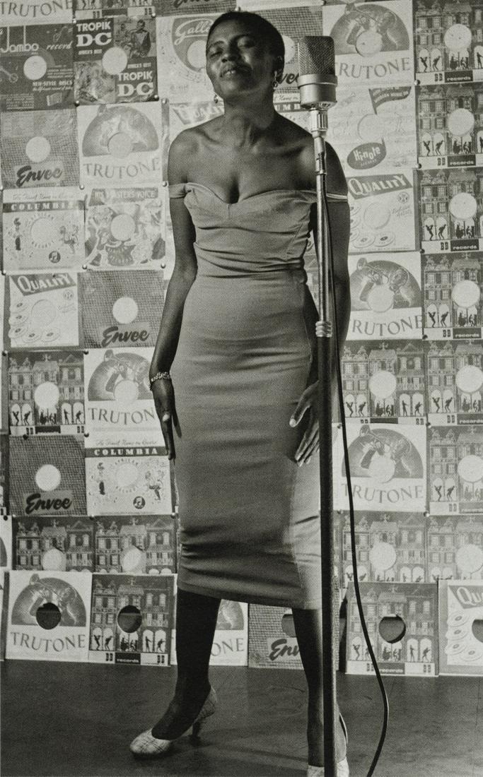 JURGEN SCHADEBERG - Miriam Makeba, Johannesburg, 1955: Artist: Jurgen Schadeberg Title: South African Singer Miriam Makeba on Stage, Johannesburg Nightclub, 1955 Medium: Photo Litho, 2009, Italy Dimensions: 4.45x7.1" Description: Heat Wax Mounted on 8.5x1