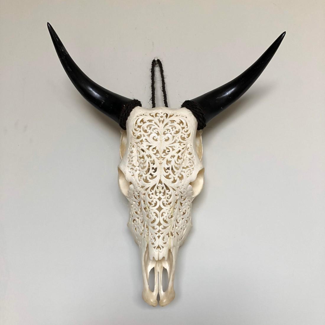 Authentic Hand Carved White Cow Skull - Traditional: Title: Authentic Hand Carved White Cow Skull - Traditional Balinese Motif Maker: Unknown Origin: Indonesia Date/Period: 2019 Materials: Bone Dimensions:H: 57 cm / 22.5 inches W: 46 cm / 18 inches Desc