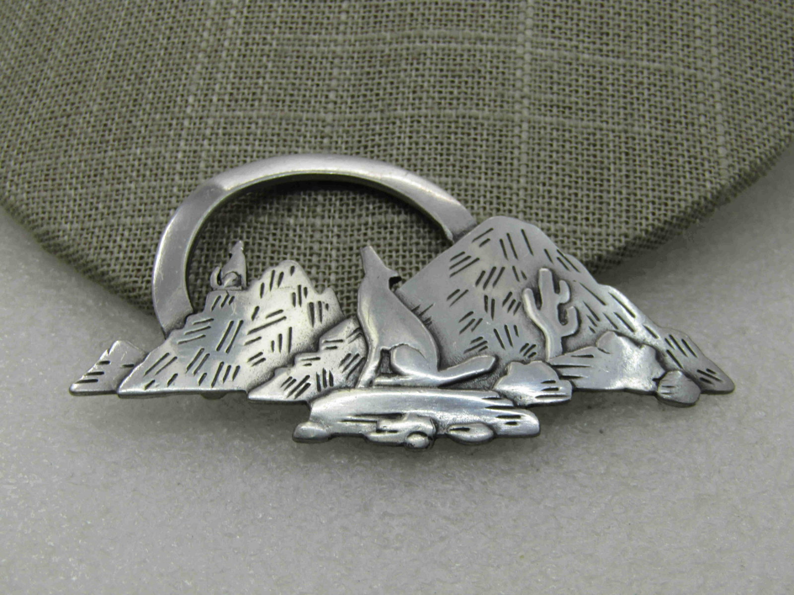 Vintage Southwestern Coyote Mountain Scene Brooch,: Vintage Southwestern Coyote Mountain Scene Brooch, Signed JJ, 3" Wide and slightly over 1.5" tall, Coyotes with their howling position looking up at the moon with mounts, rocks and cactus in the scene